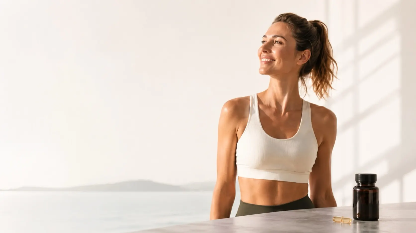 Woman in workout clothes in warm morning light next to a supplement bottle
